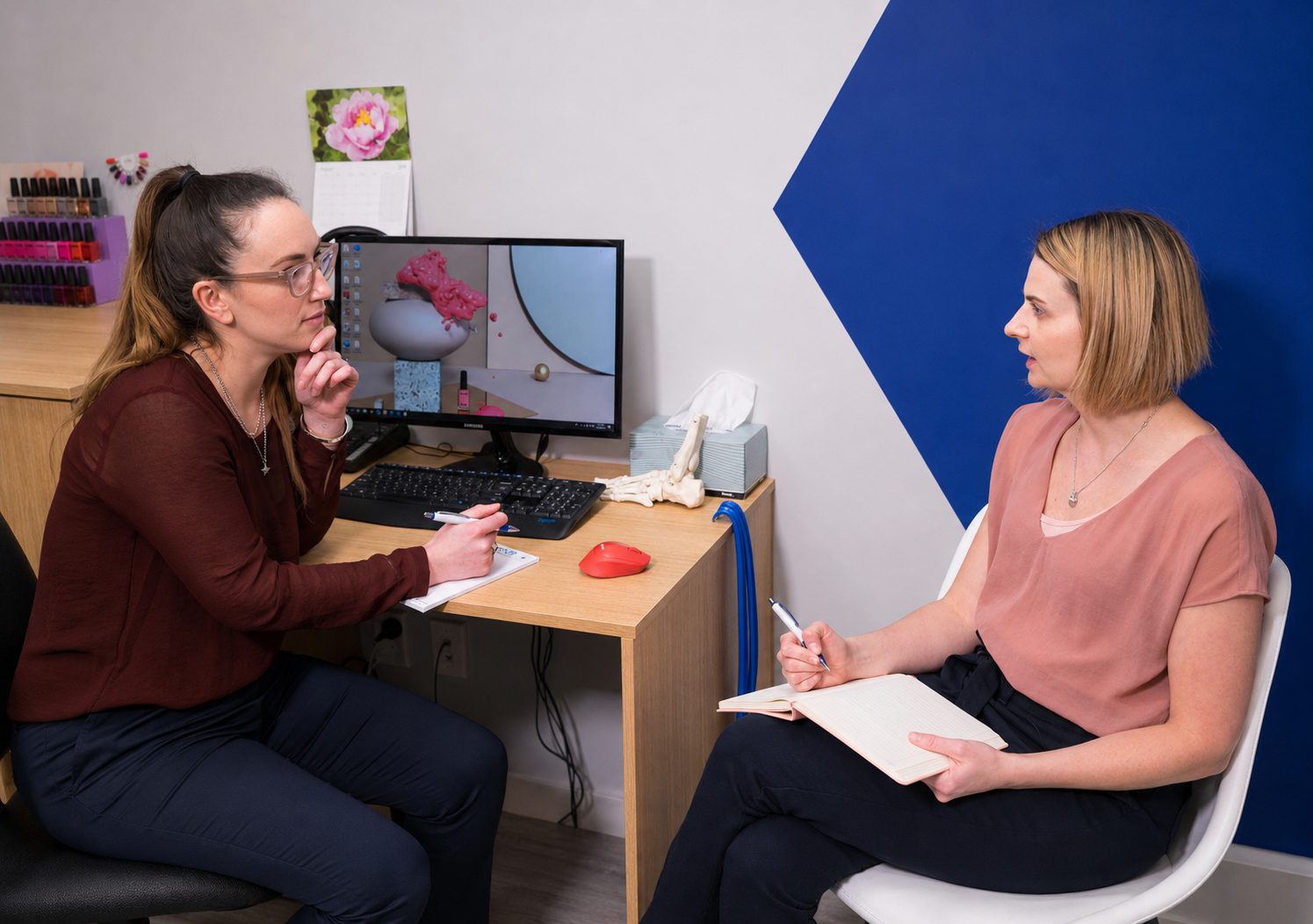 Two Capital Podiatry clinicians discussing a patient's gait-analysis results in the clinic